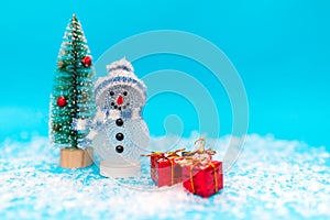 Snowman, presents and Christmas tree snow with copy space.new year celebration