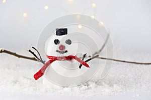 Snowman with a red scarf and black hat