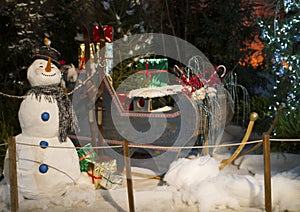 snowman with Santa sleigh and gifts to be delivered photo