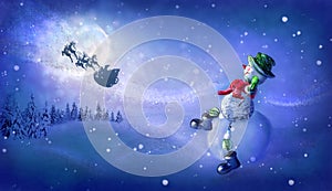 Snowman sees off Santa`s magic sleigh with reindeer flying at night over fairy forest and huge moon. Merry Christmas and