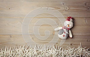 Snowman and small candles on wooden table