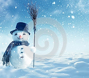 Snowman standing in winter christmas landscape