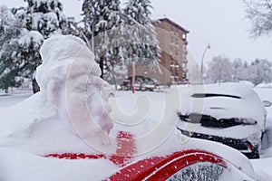 Snowman on top of a snow-covered car in Madrid\'s Filomena storm. Europe photo