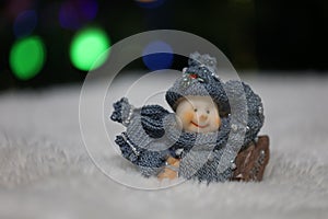 Snowman toy on table on christmas background