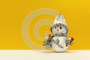Snowman on a yellow background. Christmas background. New year concept. For printing a banner, postcard or design, place