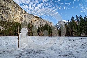 Snowman at Yosemite Valley during winter with Half Dome on background - Yosemite National Park, California, USA