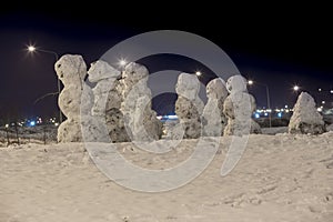 Snowmans family at december night