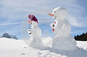 Snowmen against Swiss Alps