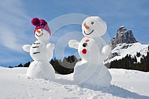 Snowmen against Swiss Alps