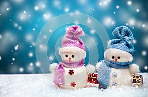 Snowmen couple with blue winter background