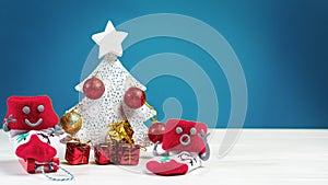 Snowmen made of Red Christmas socks around a Christmas tree with gifts. Xmas and New Year concept