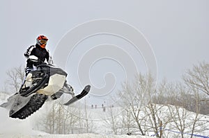 On the snowmobile rider flies sideways