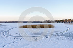 Snowmobile tracks in a frozen lake landscape photo