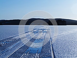 Snowmobile tracks on lake