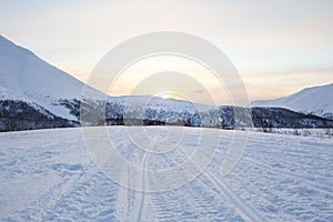 Snowmobile tracks on the snow in the mountains