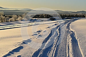 A snowmobile trail on a cold morning