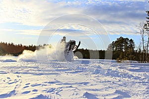 Snowmobiling in deep powder and jumping