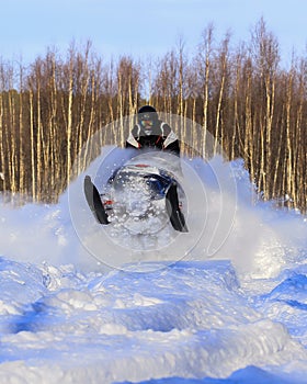 Snowmobiling in deep powder and jumping