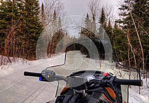 Snowmobiling through the Woods of Northern Minnesota in Winter