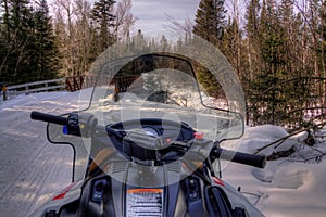 Snowmobiling through the Woods of Northern Minnesota in Winter