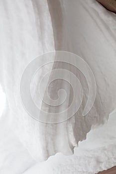 Snowpack with lines and curves structure on a house eave after a storm