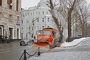 Snowplow cleans from the road snow in Moscow