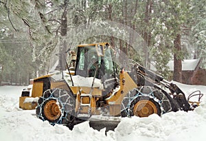 Snowplow Clearing a Residential Road in a Heavy Snowstorm