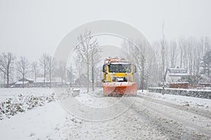 Snowplow clearing road, winter service
