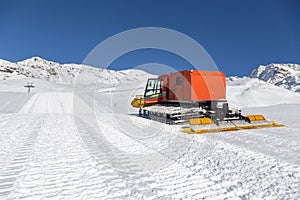 Snowplow in the mountains prepairing piste