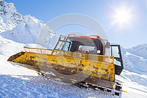 Snowplow in the mountains prepairing piste