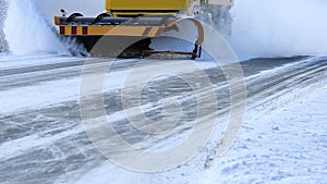 Snowplow Removes Snow Off Road photo