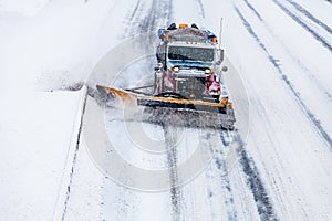 Snowplow removing the Snow from the Highway during a Snowstorm