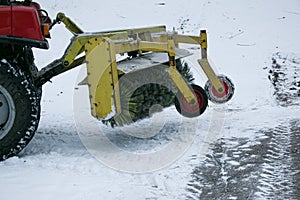 Snowplow removing snow on street after blizzard. Snowplow vehicle clears snowy road during blizzard. Snow clearing equipment.