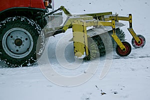 Snowplow removing snow on street after blizzard. Snowplow vehicle clears snowy road during blizzard. Snow clearing equipment.