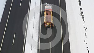 Snowplow Truck Driving Along Highway And Spray Salt And Reagents On The Road