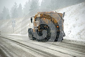 Snowplow truck on icy road