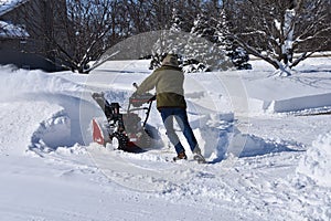 Snowplowing a driveway and sidewalk after a blizzard