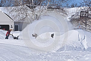 Snowplowing a driveway and sidewalk after a blizzard