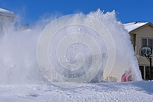 Snowplowing a driveway and sidewalk after a blizzard