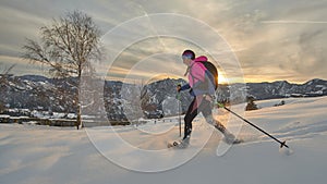 A snowshoe girl in a beautiful winter sunset