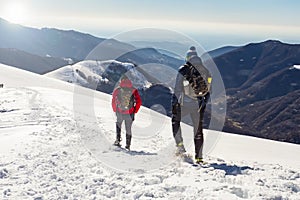 Snowshoeing scene in the italian alps photo