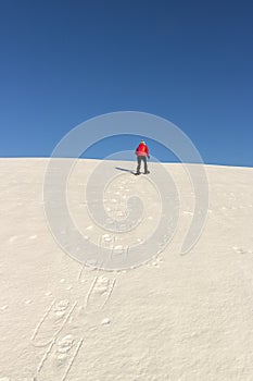 Snowshoeing - woman trekking with snowshoes