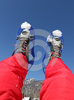 Snowshoes and Red Ski suit in the mountains photo