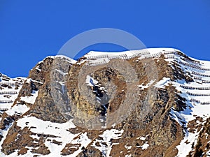 Snowy alpine mountain peak Pointe des Semeleys located in a mountain massif of the Bernese Alps Alpes bernoises, Les Diablerets photo
