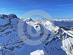 Snowy alpine mountain peaks Le Sommet des Diablerets and TÃªte Ronde located in the mountain massif Les Diablerets - Switzerland