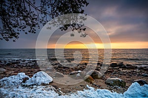 Snowy beach in Gdynia Orlowo at sunrise, Baltic Sea. Poland