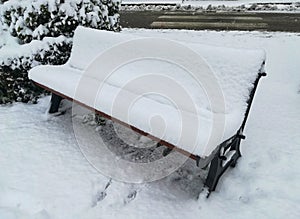 Snowy bench in the city
