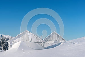 Snowy cabin in the winter mountains