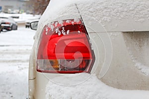 Snowy car tail light. Safety on winter roads