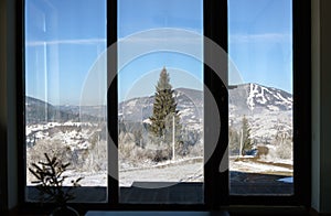 Snowy carpathian Mountain view from big window in Ukraine